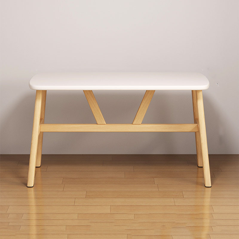 Bench with white top and wooden legs, side view